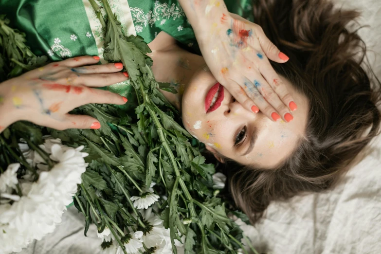 there is a woman laying down with flowers