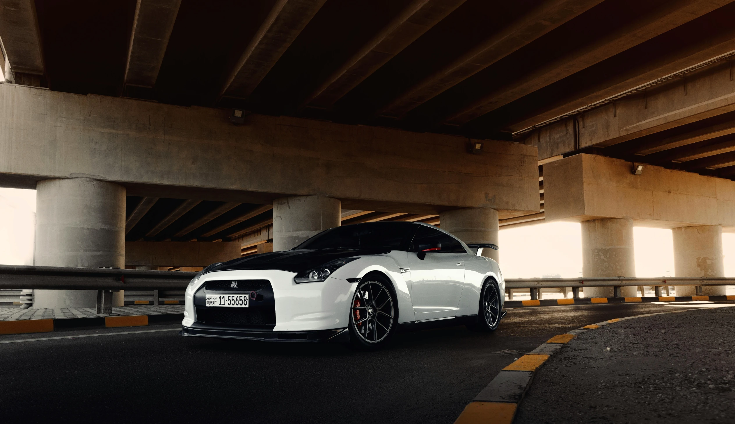 a white sports car is parked on the road