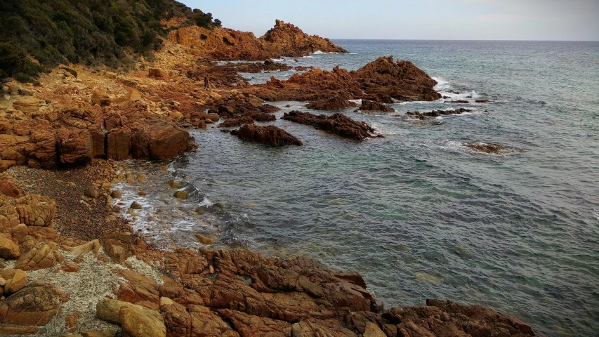 an ocean cliff is seen near the shore