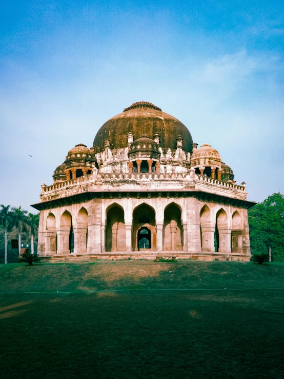 a large ornate building in the middle of a field