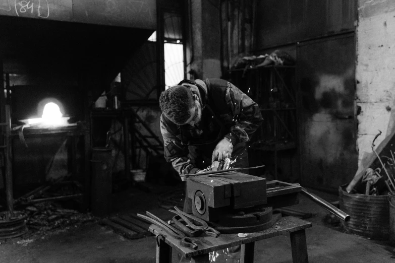 an older man operating a machine while standing in a warehouse