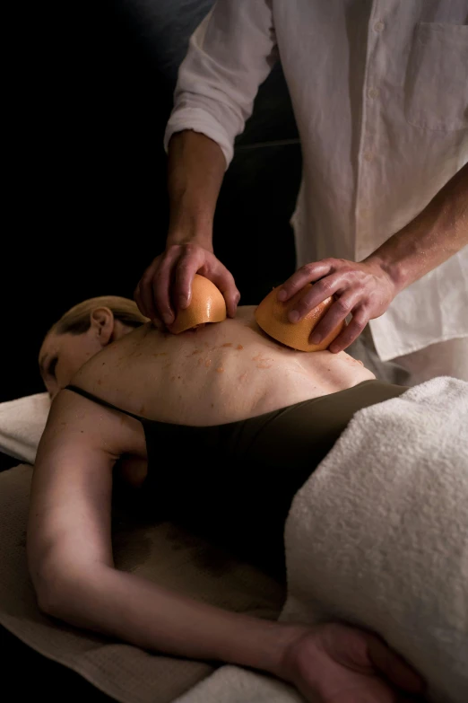 person in a white shirt having an arm massage