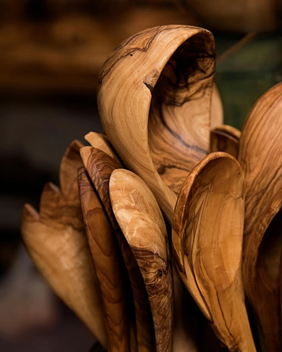 a wooden spoon full of bananas sitting on a table