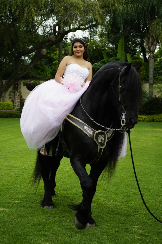 a girl riding on the back of a black horse