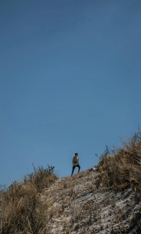 two people standing on the top of a steep hill