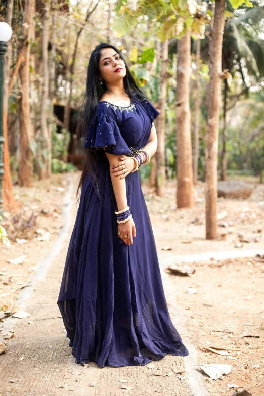 a woman in a blue dress posing for the camera