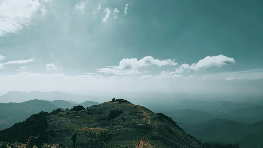 a green mountain landscape is pictured during sunset