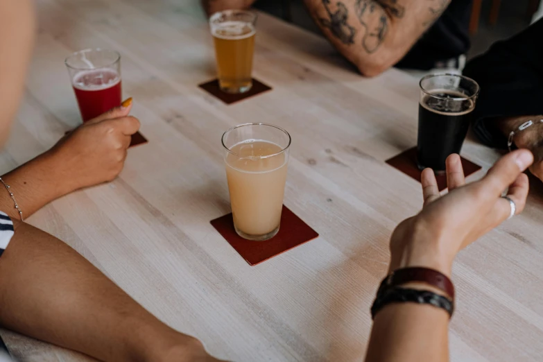 people sitting at a table sharing drinks