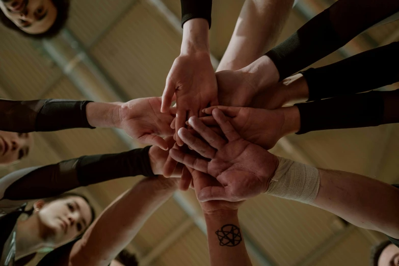 a bunch of people that have their hands together