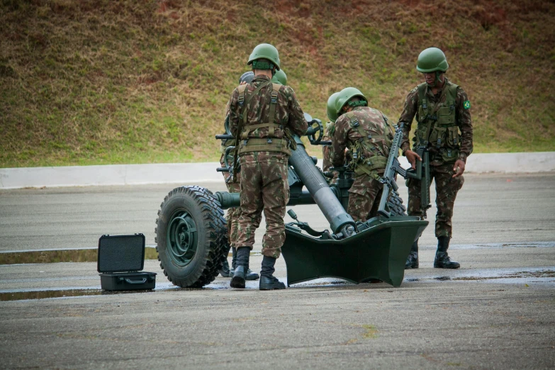 soldiers are putting a giant round object inside the wheel of a vehicle