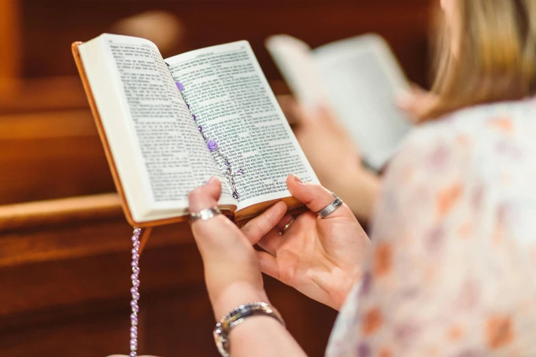 a woman with a ring reading a book