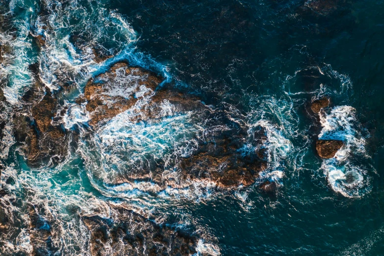 a po taken from a airplane shows a rock outcropping by the ocean