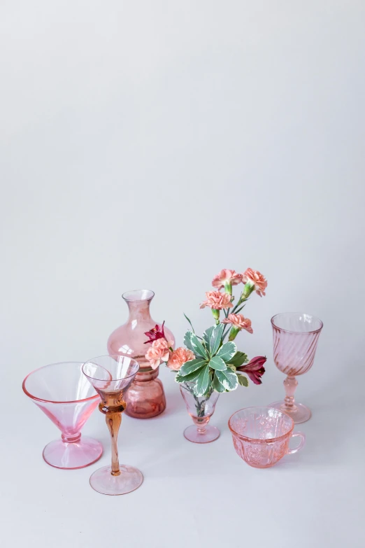 there is flowers in some glass vases and plates