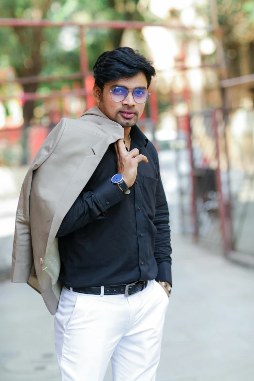 a man standing on a sidewalk wearing sunglasses and a jacket