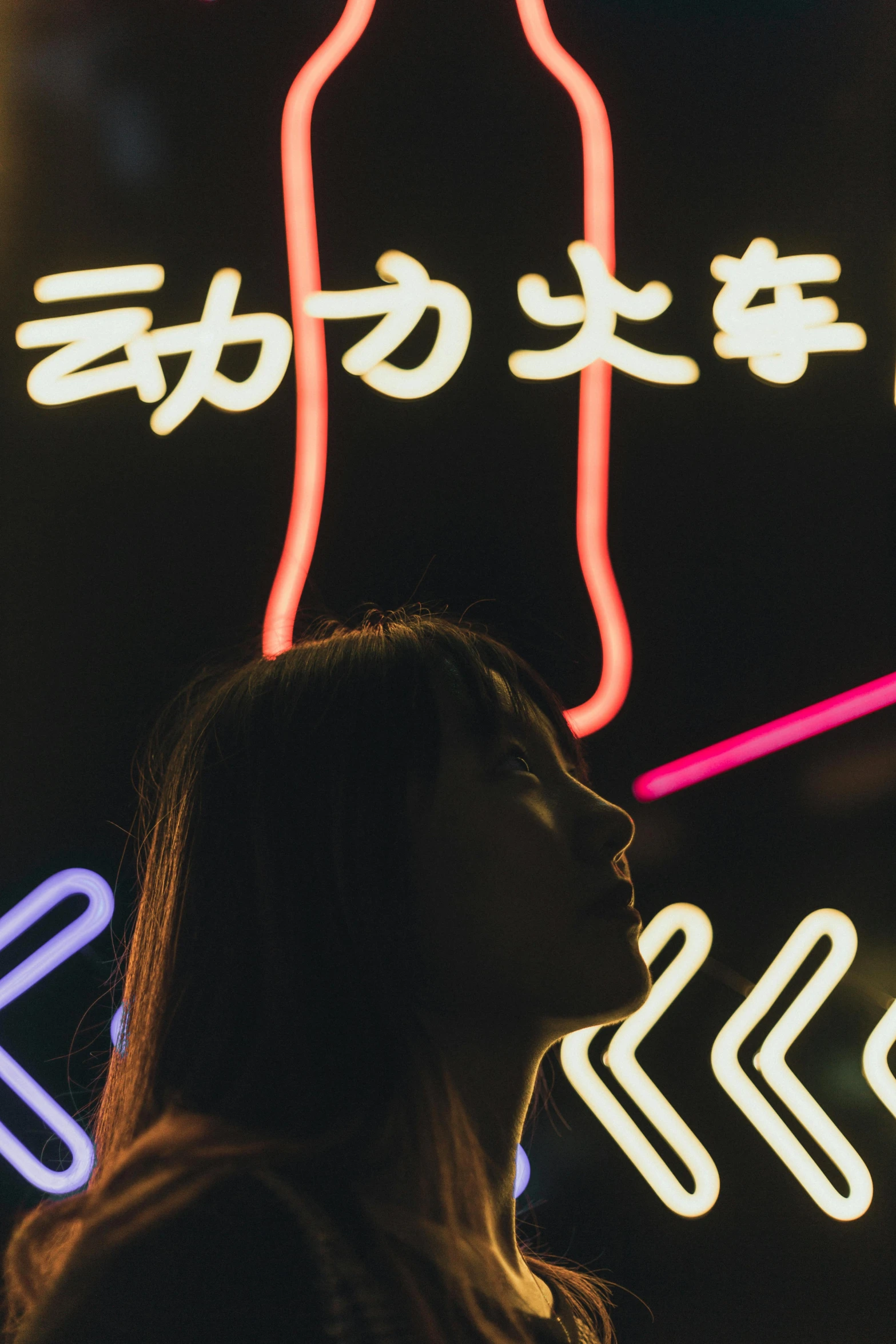 a woman standing in front of a sign for a store