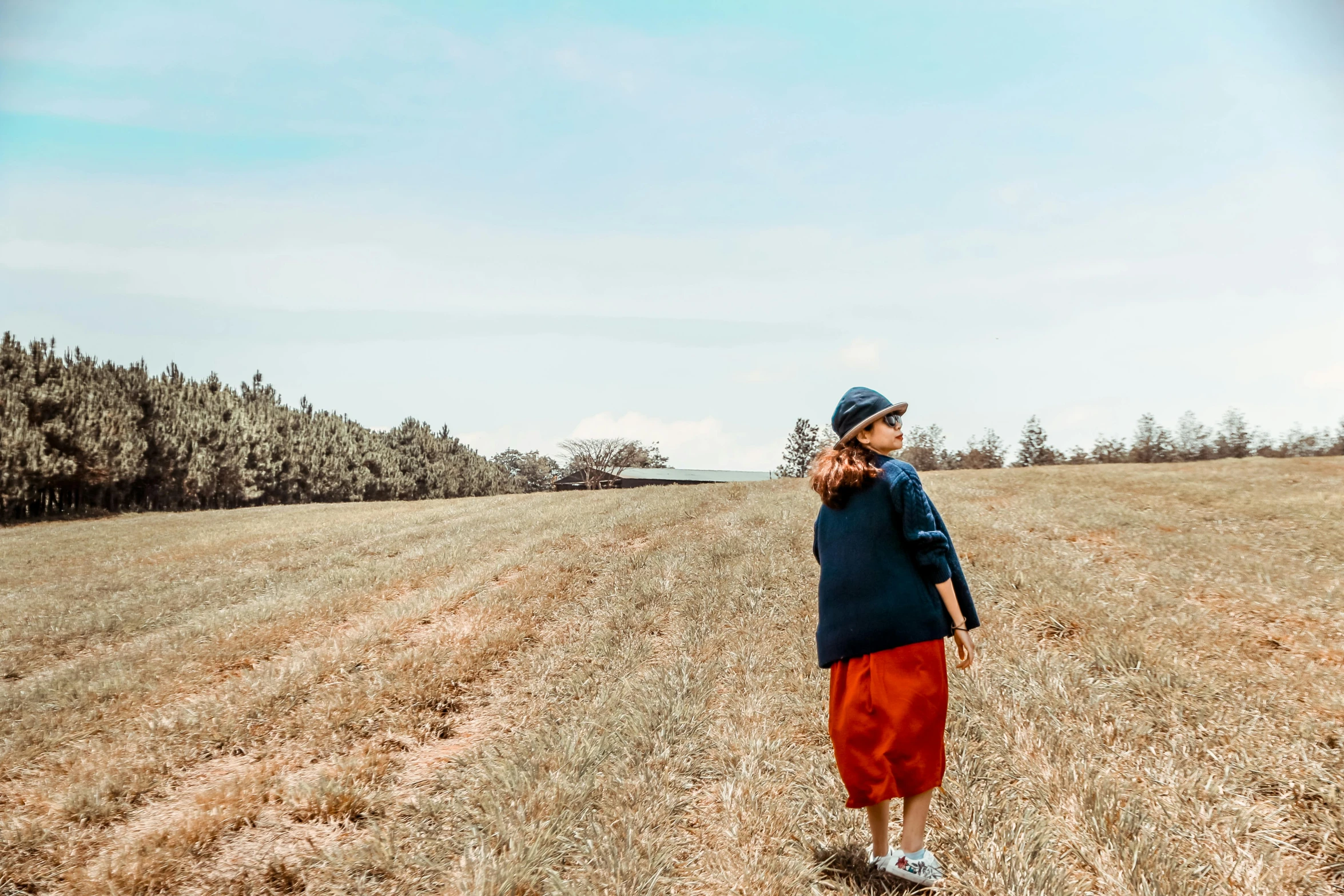 the young man is in the big field with his hat on