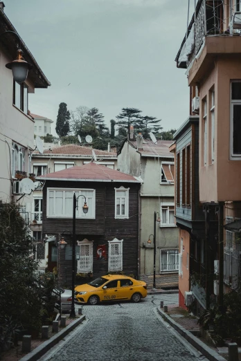 a yellow car parked in front of some buildings