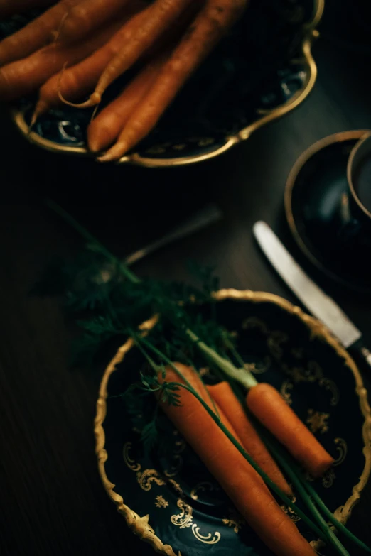 a couple of plates holding carrots and garlic