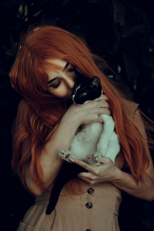 a young woman is petting her cat by its head