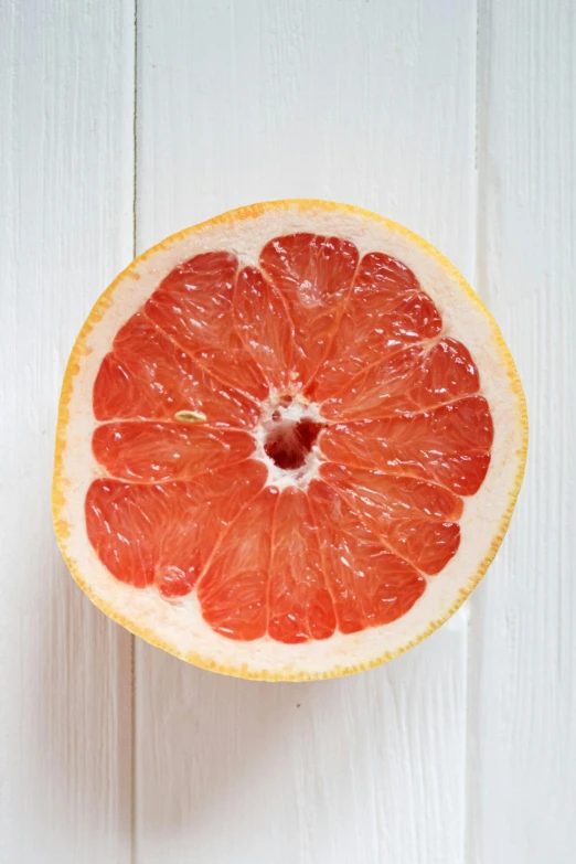  orange sliced up on a white table