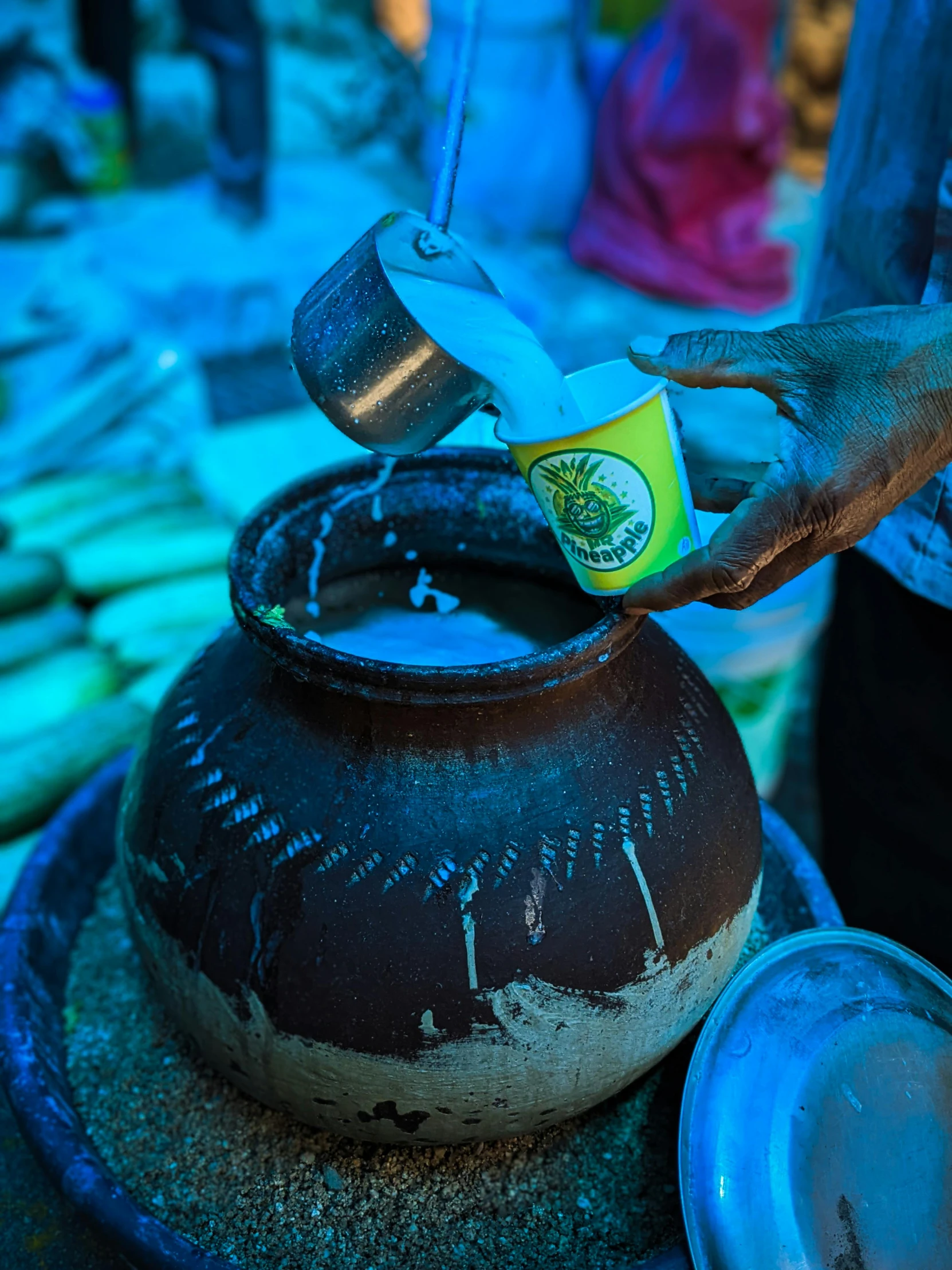 a person putting some kind of food in a pot