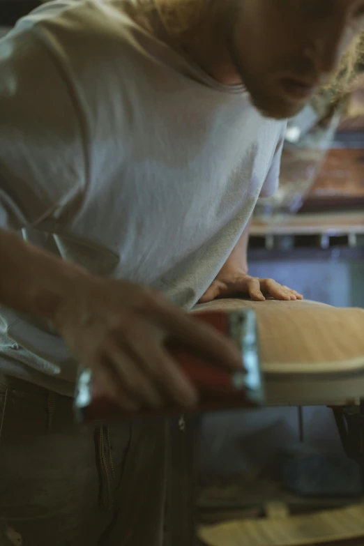 the man is working with the wooden paddle