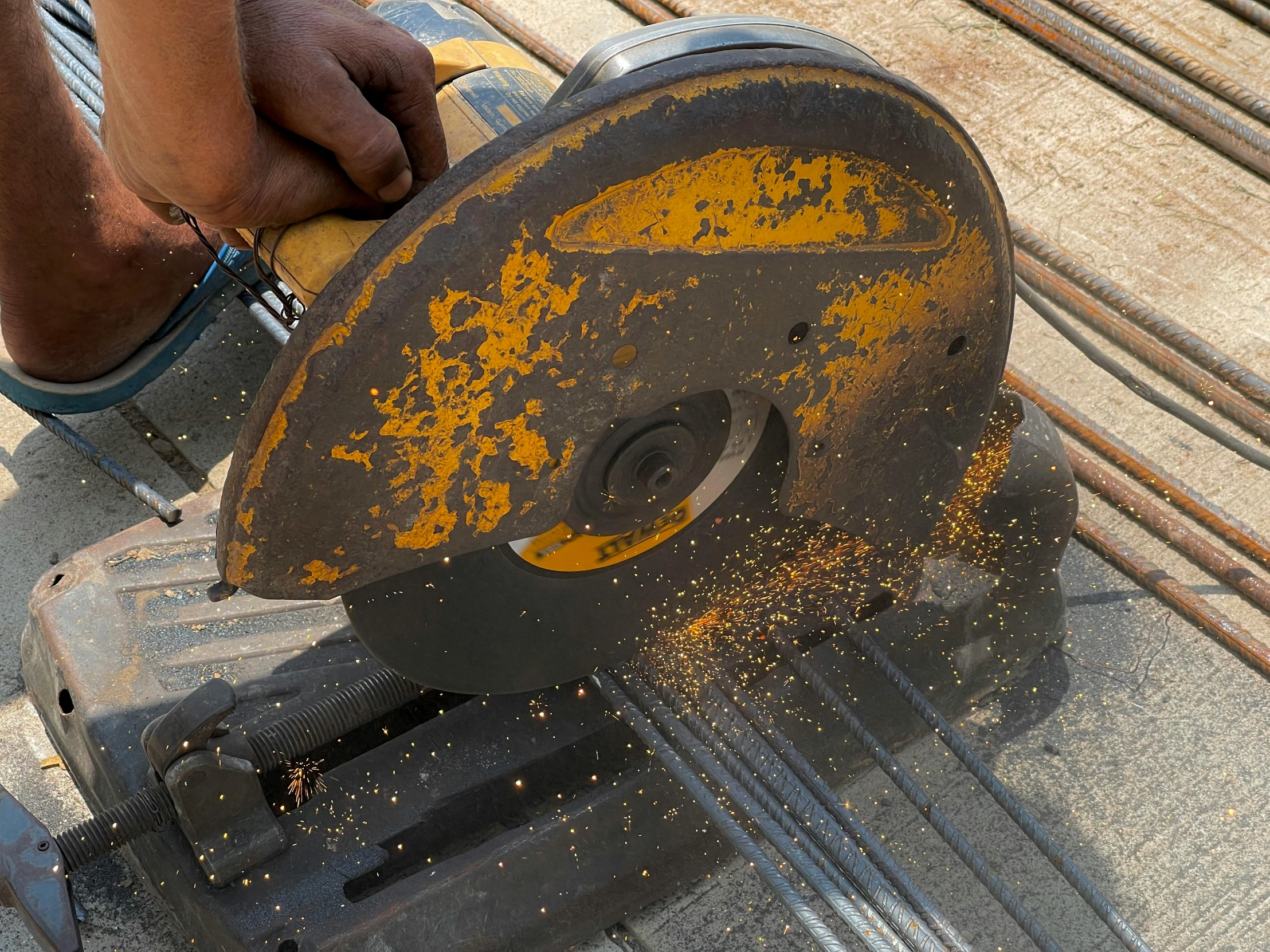 a person  through a metal object with a grinder