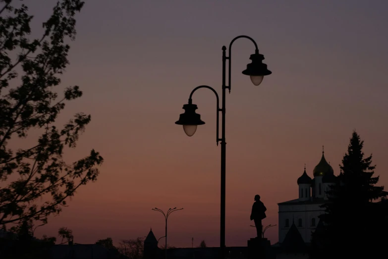 street lamp with two street lamps sitting next to it