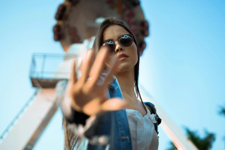 a young woman taking a po of a ferris wheel