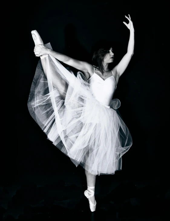 black and white pograph of a woman wearing a ballet dress