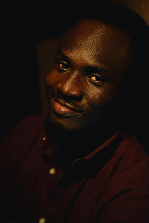 a close - up of a man smiling in the dark