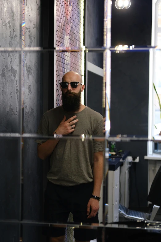 a man with a beard in his shirt looking at himself