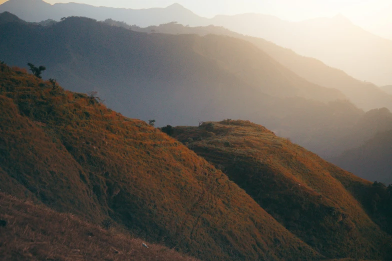 a couple of people are sitting on the top of a hill