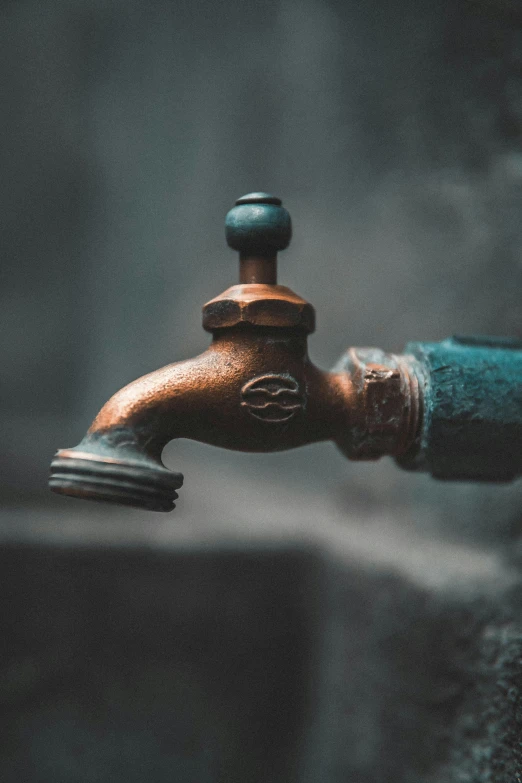 an old rusted faucet in the bathroom that looks like a spout