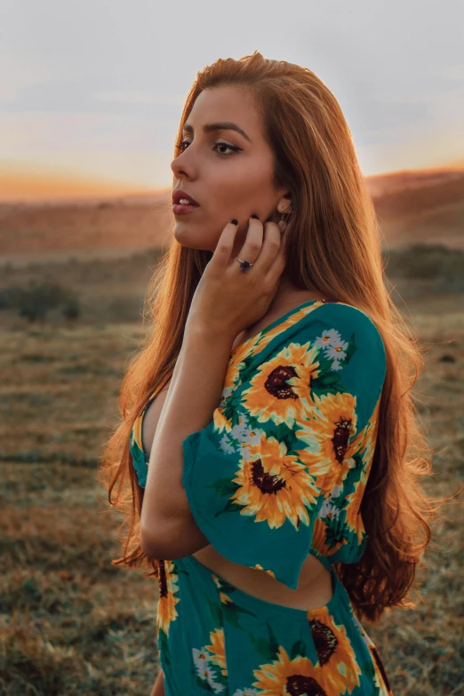 a young woman is holding her hand to her face