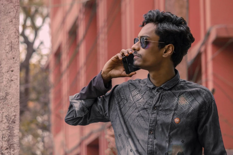 a man in sunglasses talking on a cell phone