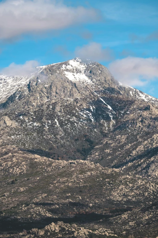 a mountain side with the sky in the background