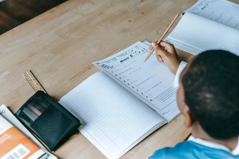 a man writing in a notepad and taking notes