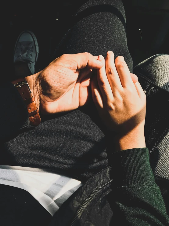 two people holding hands above their head