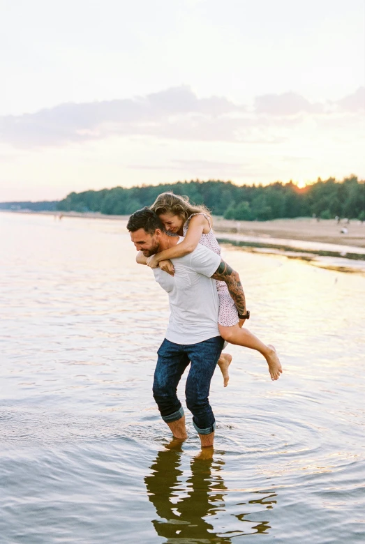 two people are holding one another in the water