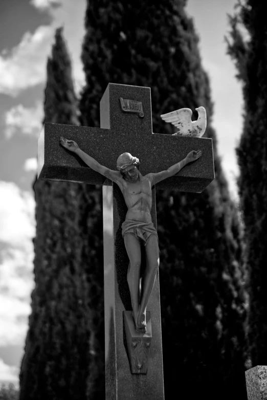 a statue of jesus on top of a cross