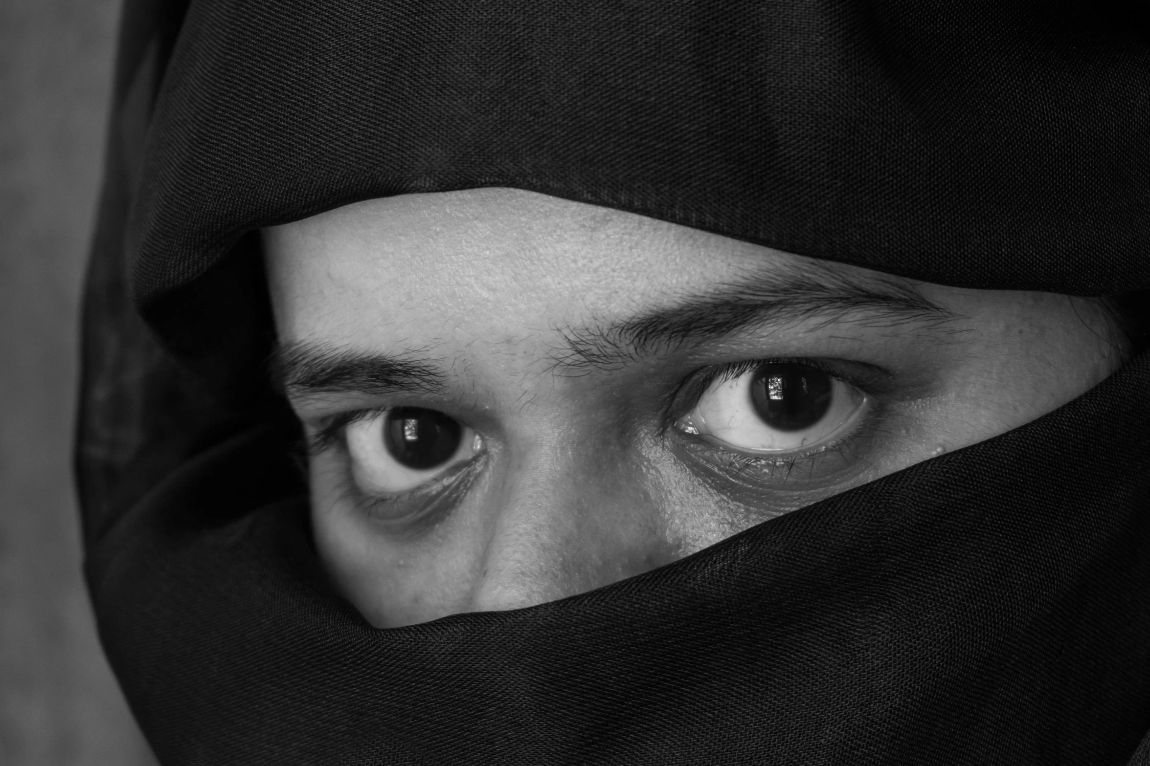 a person's eyes are partially hidden by the hood