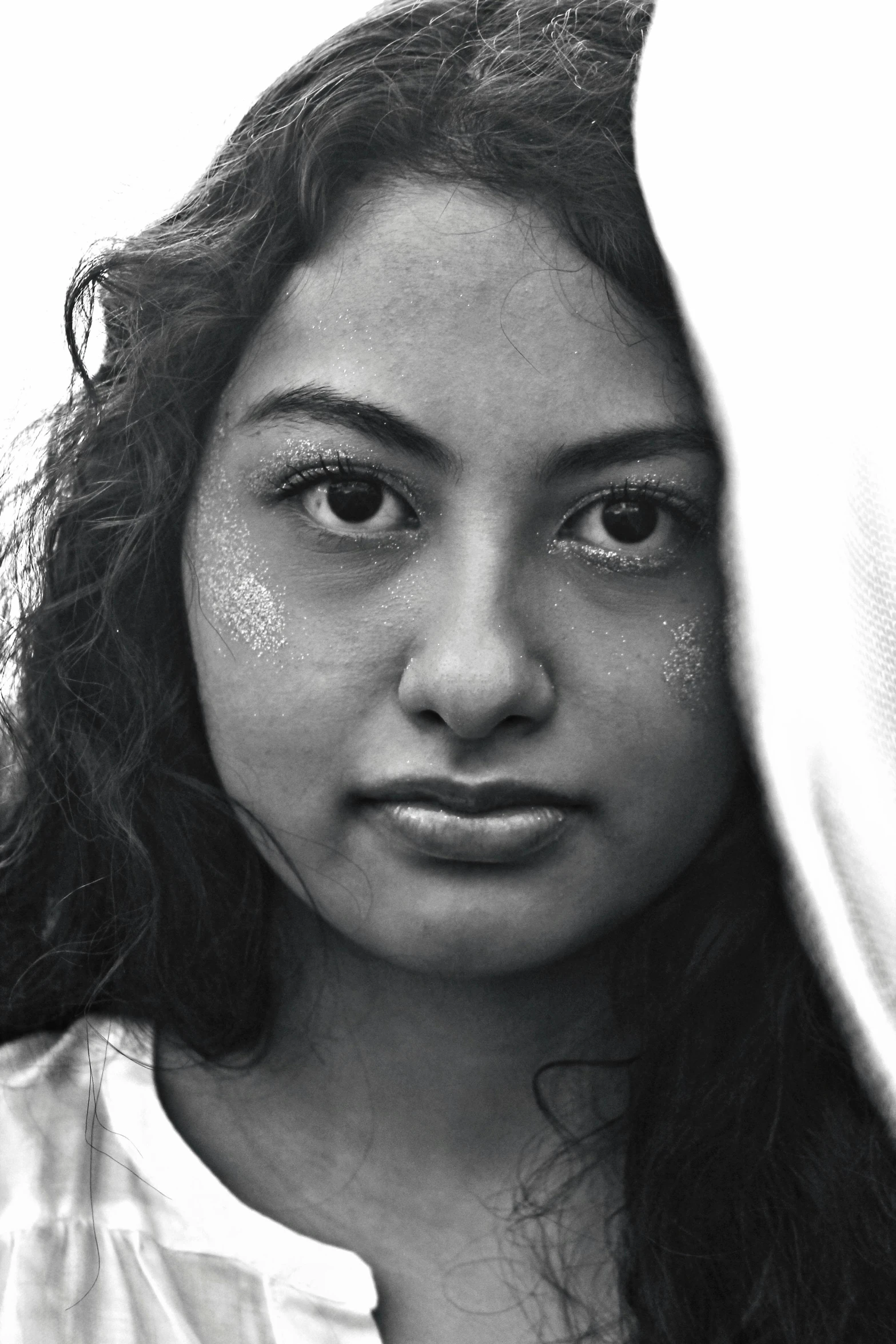 a young woman is holding her face near her neck