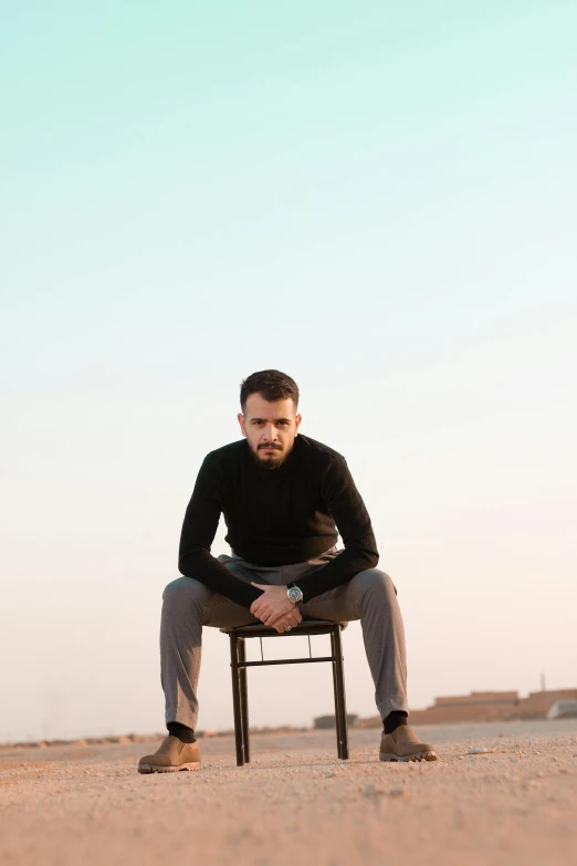 a man sitting in a chair in the middle of nowhere