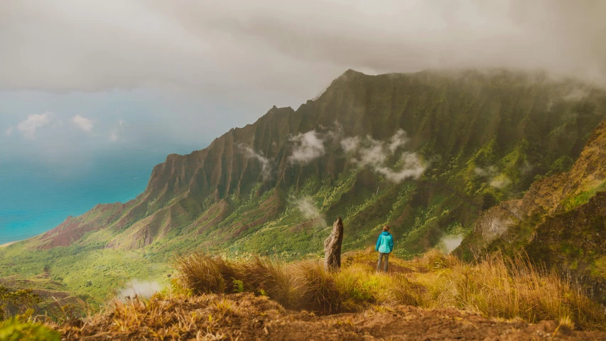 a woman hiking up the side of a steep mountain