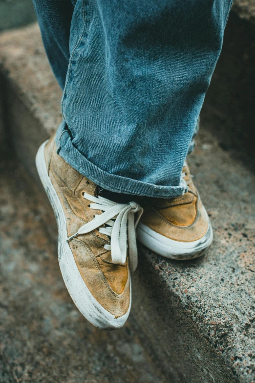 someone standing on top of stairs with a pair of shoes