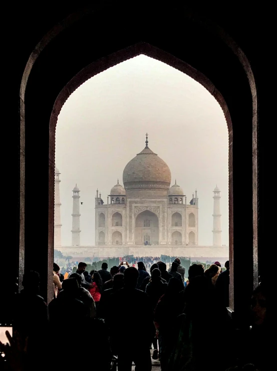 a large crowd of people standing around a building