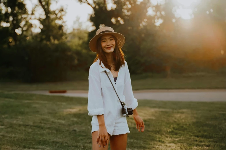 a woman is standing in the grass smiling