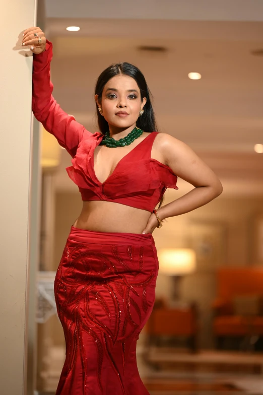 woman in red outfit posing in the middle of an entry way