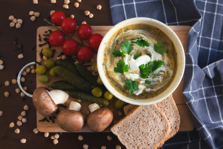 a tray with a soup and bread on it